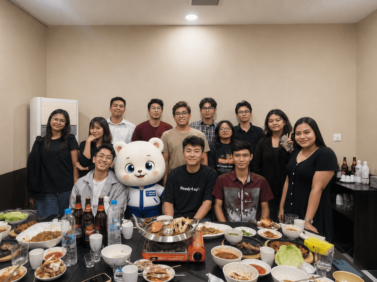 The ITWizard Myanmar team together at dinner, with the mascot among them
